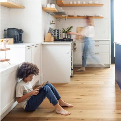 Modern kitchen with beautiful hardwood flooring and family enjoying the space